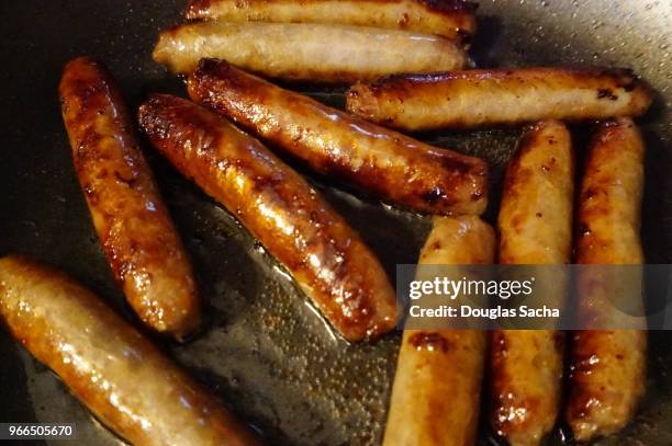 healthy turkey sausage links cooking on a skillet - breakfast sausage stock pictures, royalty-free photos & images