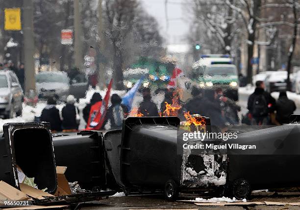 Left-wing counter demonstrator blockade a street with burning trash bins on February 13, 2010 in Dresden, Germany. Right-wing Neo-Nazis and their...