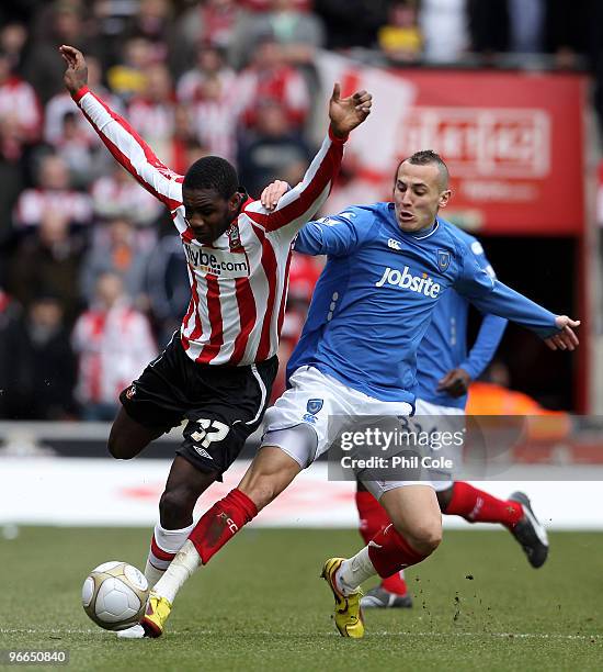 Michail Antonio of Southampton gets tackled by Hasan Yebda of Portsmouth during the FA Cup sponsored by E.ON fifth round match between Southampton...