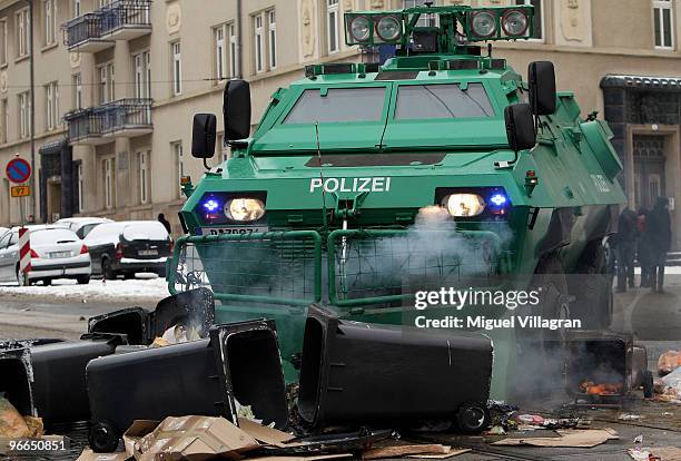 German riot police men remove a burning set on fire by left-wing counter demonstrators with a bulldozer on February 13, 2010 in Dresden, Germany....