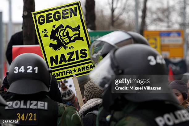 German riot police stand guard in front left-wing counter demonstrators next to the railway station 'Neustadt', where the Neo-Nazis are going to...