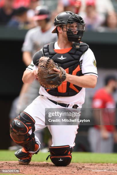 Andrew Susac of the Baltimore Orioles looks to throw to second base during a baseball game against the Washington Nationals at Oriole Park at Camden...