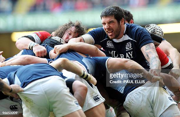 Welsh prop Adam Jones and Scotland's Jim Hamilton push in a ruck during the RBS Six Nations International rugby union match between Wales and...