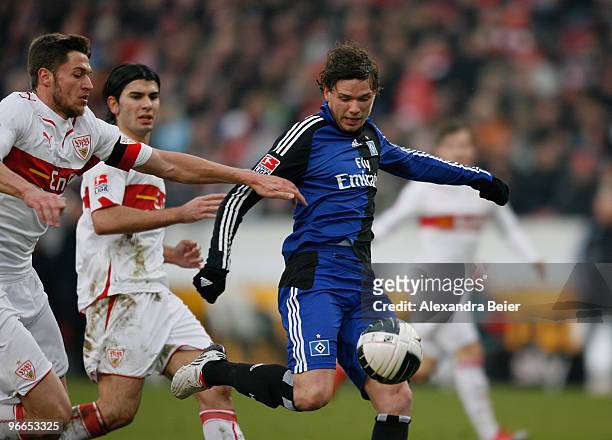 Matthieu Delpierre and Serdar Tasci of VfB Stuttgart miss to stop Marcus Berg of Hamburger SV scoring his first goal during the Bundesliga first...