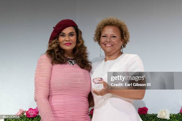 Tina Knowles and Debra Lee pose for a photo onstage at the Ladylike Foundation's 2018 Annual Women Of Excellence Scholarship Luncheon at The Beverly...