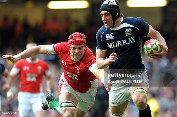 Scotland flanker Kelly Brown runs clear of Welsh lock Alun-Wyn Jones during the RBS Six Nations International rugby union match between Wales and...