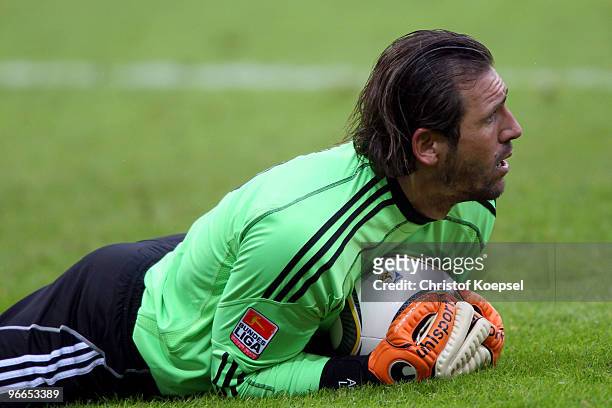 André Lenz of Wolfsburg saves the ball during the Bundesliga match between Bayer Leverkusen and VfL Wolfsburg at the BayArena on February 13, 2010 in...