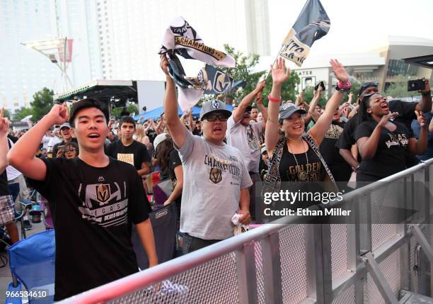 Vegas Golden Knights fans Ryen Sugimoto, Rich Sugimoto, and Lisa Furukawo, all of Nevada, react after Tomas Nosek of the Golden Knights scored a...