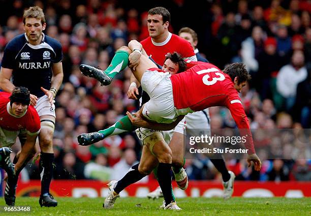 Scotland player Max Evans puts in a tackle on James Hook of Wales during the RBS 6 Nations Championship match between Wales and Scotland at the...