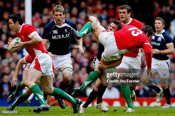 Scotland player Max Evans puts in a tackle on James Hook of Wales during the RBS 6 Nations Championship match between Wales and Scotland at the...