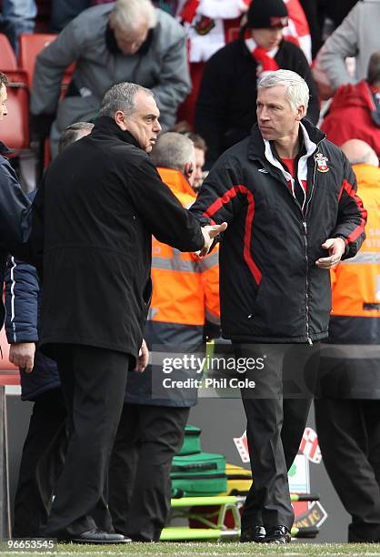 Alan Pardew manager of Southampton shakes hands with Avram Grant manager of Portsmouth at the end of the FA Cup sponsored by E.ON fifth round match...