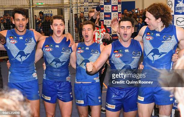 Scott Thompson, Tom Murphy, Kayne Turner, Paul Ahern and Ben Brown of the Kangaroos sing the song in the rooms after winning the round 11 AFL match...