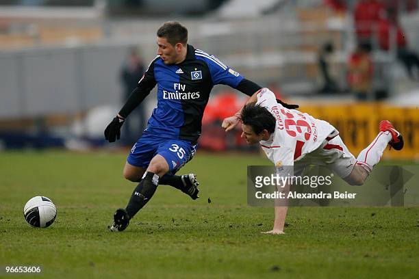 Christian Traesch of VfB Stuttgart fights for the ball with Tunay Torun of Hamburger SV during the Bundesliga first division soccer match between VfB...