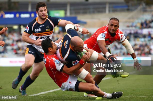 Lachy McCaffrey of the Brumbies is tackled during the round 16 Super Rugby match between the Brumbies and the Sunwolves at GIO Stadium Stadium on...