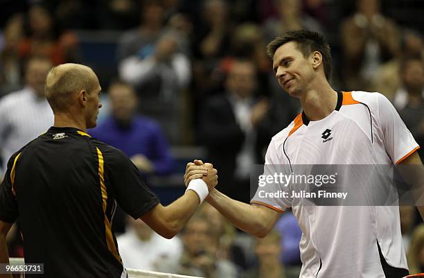 Robin Soderling of Sweden shakes hands with Nikolay Davydenko of Russia after winning in straight sets during day six of the ABN AMBRO World Tennis...
