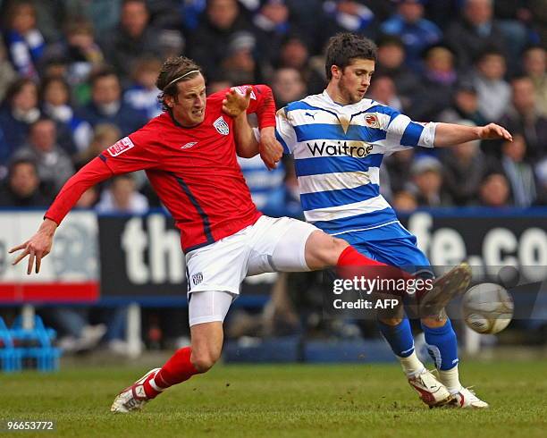 West Bromwich Albion's Swedish defender Jonas Olsson vies with Reading's Irish striker Shane Long during the FA Cup fifth round football match...