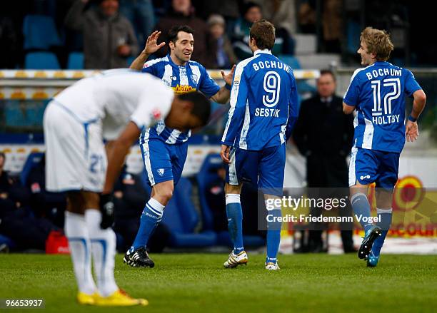 Stanislav Sestak of Bochum celebrates scoring the first goal with Matias Concha and Lewis Holtby during the Bundesliga match between VfL Bochum and...