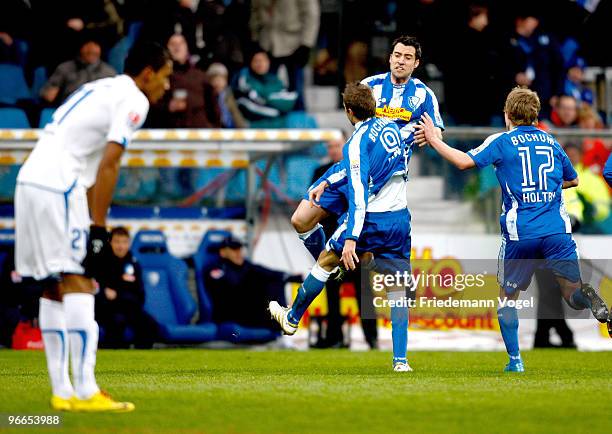 Stanislav Sestak of Bochum celebrates scoring the first goal with Matias Concha and Lewis Holtby during the Bundesliga match between VfL Bochum and...