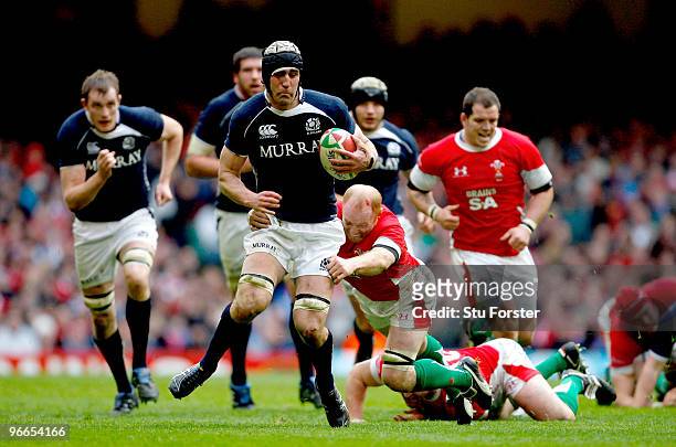 Scotland player Kelly Brown runs through the challenge of Martyn Williams during the RBS 6 Nations Championship match between Wales and Scotland at...