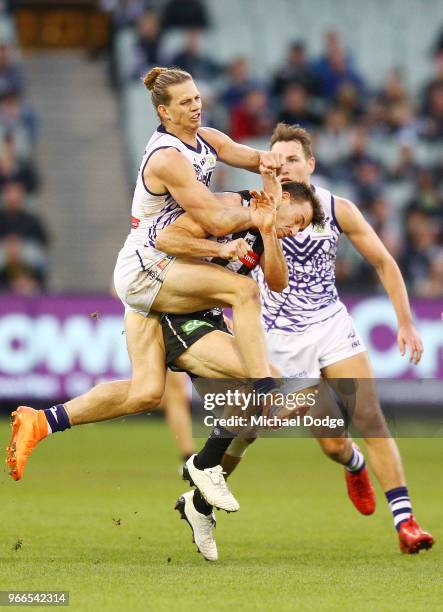 Nat Fyfe of the Dockers hits Levi Greenwood of the Magpies high in a late contest for the ball during the round 11 AFL match between the Collingwood...