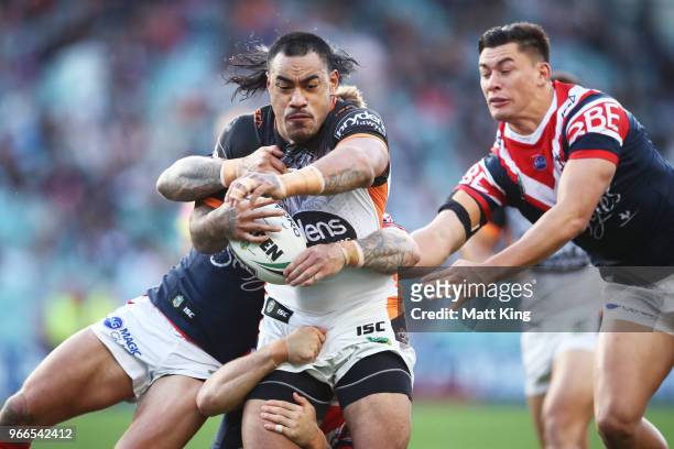 Mahe Fonua of the Tigers is tackled during the round 13 NRL match between the Sydney Roosters and the Wests Tigers at Allianz Stadium on June 3, 2018...