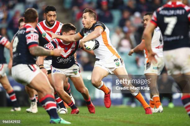 Josh Reynolds of the Tigers takes on the defence during the round 13 NRL match between the Sydney Roosters and the Wests Tigers at Allianz Stadium on...