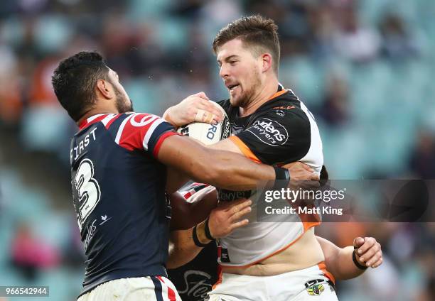 Matt Eisenhuth of the Tigers is tackled during the round 13 NRL match between the Sydney Roosters and the Wests Tigers at Allianz Stadium on June 3,...