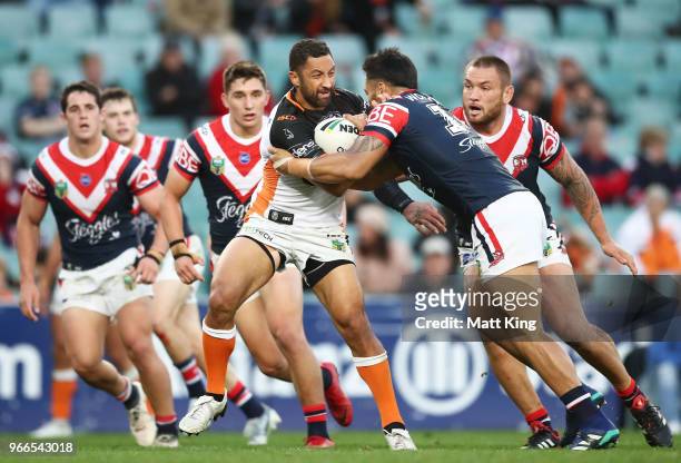 Benji Marshall of the Tigers is tackled during the round 13 NRL match between the Sydney Roosters and the Wests Tigers at Allianz Stadium on June 3,...