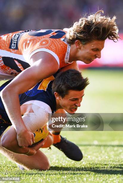 Lachie Whitfield of the Giants tackles Matt Crouch of the Adelaide Crows during the round 11 AFL match between the Adelaide Crows and the Greater...