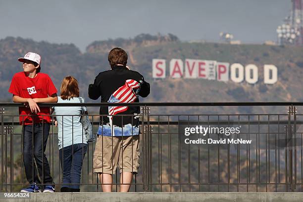 Visitors to the Hollywood and Highland complex take in the sights as activists continue covering the iconic 450-foot-long Hollywood sign with banners...