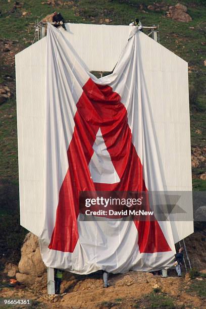 Activists begin covering up the iconic 450-foot-long Hollywood sign during an effort to prevent the building of houses there on February 11, 2010 in...