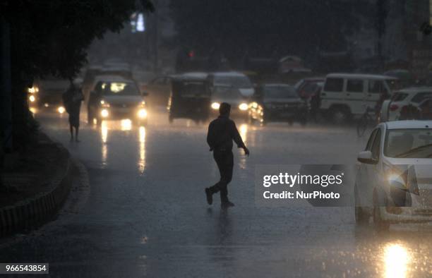 Commuter and pedestrians look on the traffic as pre-monsoon rain clouds hoving in the sky before the downpour in the eastern Indian state Odisha's...