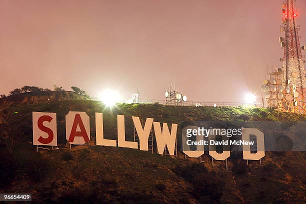 Activists stop for the night after beginning to cover up the iconic 450-foot-long Hollywood sign during an effort to prevent the building of houses...