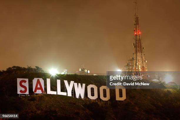 The light of a police helicopter illuminates the work of activists after they stop work for the night on covering up the iconic 450-foot-long...