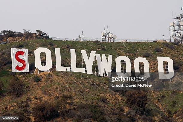 Activists begin covering up the iconic 450-foot-long Hollywood sign during an effort to prevent the building of houses there on February 11, 2010 in...