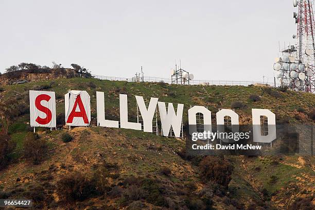 Activists begin covering up the iconic 450-foot-long Hollywood sign during an effort to prevent the building of houses there on February 11, 2010 in...