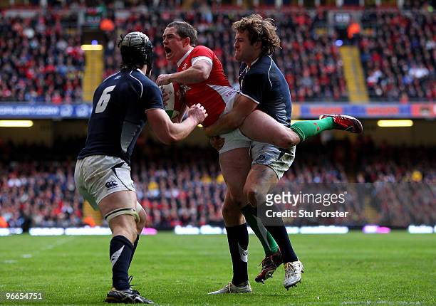 Scotland players Kelly Brown and Rory Lamont can't stop Shane Williams of Wales collecting the ball from a high punt in his own end zoner during the...