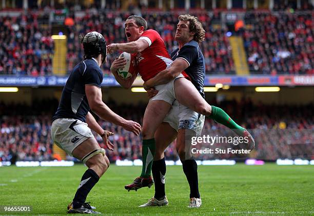 Scotland players Kelly Brown and Rory Lamont can't stop Shane Williams of Wales collecting the ball from a high punt in his own end zoner during the...