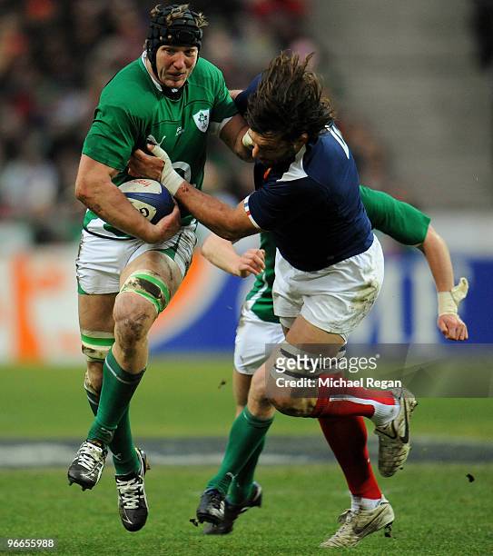 Stephen Ferris of Ireland is tackled by Lionel Nallet of France during the RBS Six Nations match between France and Ireland at the Stade France on...