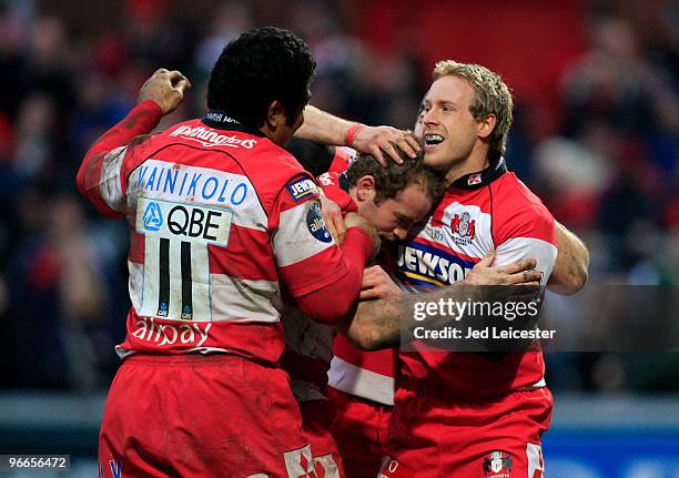 Gloucester players Olly Morgan and Lesley Vainikolo celebrate with try scorer James Simpson-Dainel during the Guinness Premiership match between...