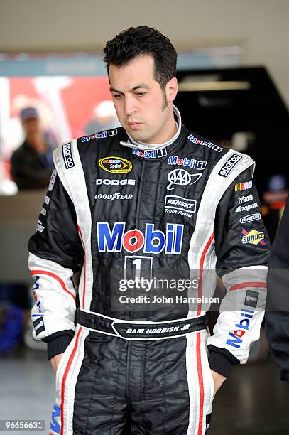 Sam Hornish Jr. , driver of the Mobil 1 Dodge, stands in the garage area during practice for the Daytona 500 at Daytona International Speedway on...