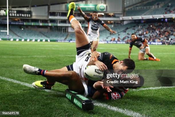 Corey Thompson of the Tigers is tackled over the line in the corner by Daniel Tupou of the Roosters in the final minutes during the round 13 NRL...