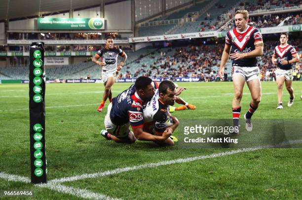 Corey Thompson of the Tigers is tackled over the line in the corner by Daniel Tupou of the Roosters in the final minutes during the round 13 NRL...
