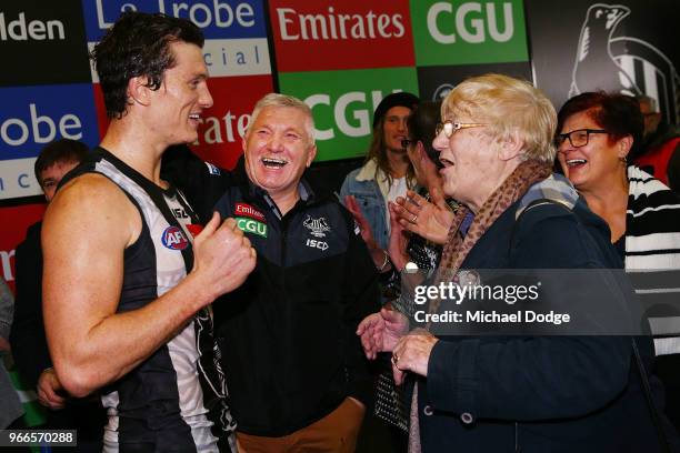 Brody Mihocek of the Magpies celebrates the win with his father Jack Mihocek and his grandmother during the round 11 AFL match between the...