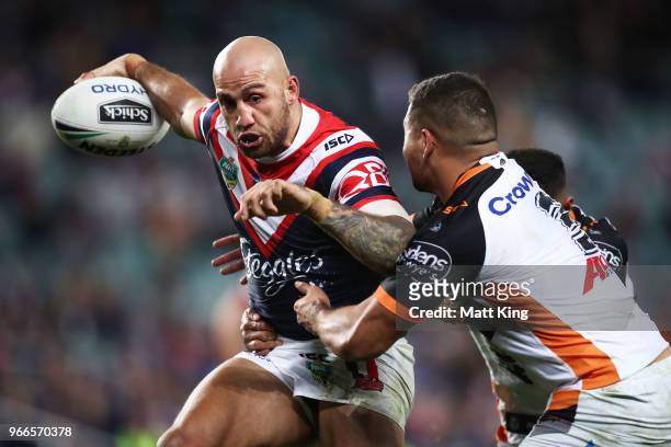 Blake Ferguson of the Roosters takes on the defence during the round 13 NRL match between the Sydney Roosters and the Wests Tigers at Allianz Stadium...