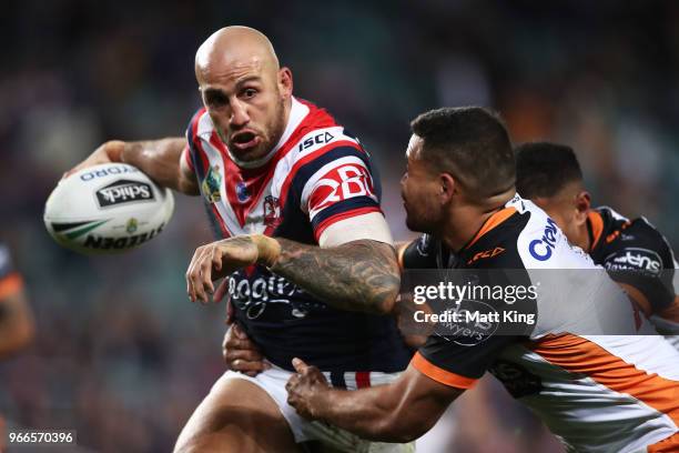 Blake Ferguson of the Roosters takes on the defence during the round 13 NRL match between the Sydney Roosters and the Wests Tigers at Allianz Stadium...