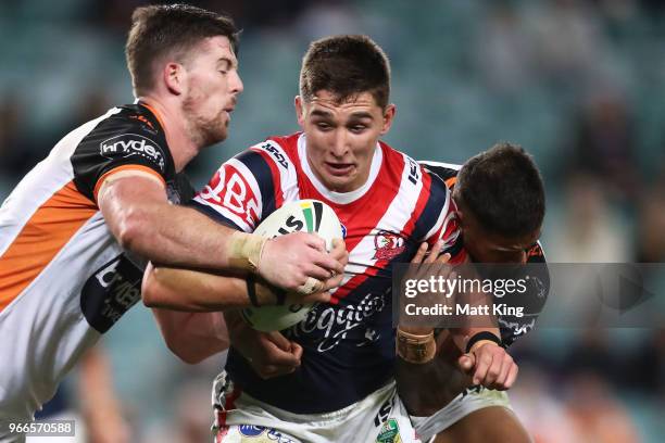 Victor Radley of the Roosters is tackled during the round 13 NRL match between the Sydney Roosters and the Wests Tigers at Allianz Stadium on June 3,...