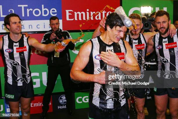 Brody Mihocek of the Magpies celebrates the win in his first match with teammates during the round 11 AFL match between the Collingwood Magpies and...