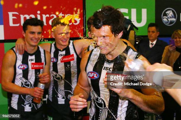 Brody Mihocek of the Magpies celebrates the win in his first match with teammates during the round 11 AFL match between the Collingwood Magpies and...