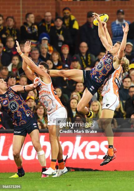 Paul Seedsman of the Adelaide Crows flys high in front of Nick Haynes of the Giants during the round 11 AFL match between the Adelaide Crows and the...